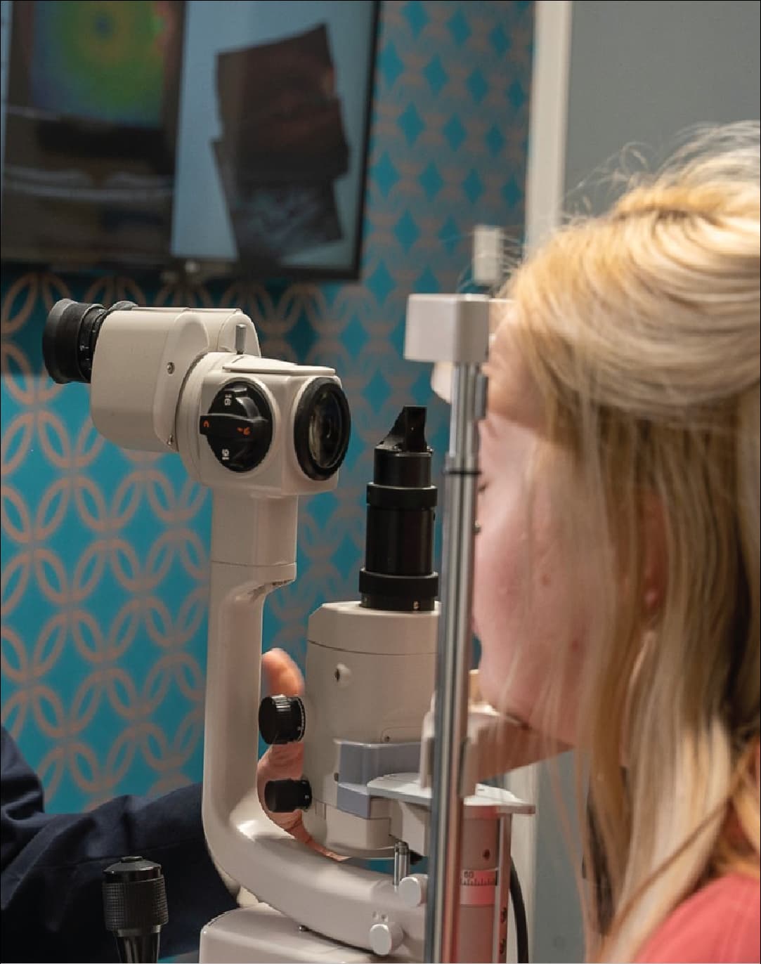 An optometrist examining a patient with a slit lamp at Pollards